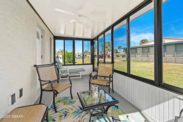 sunroom / solarium featuring ceiling fan