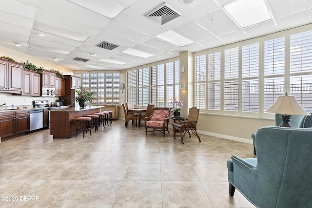 interior space with a drop ceiling, plenty of natural light, and sink