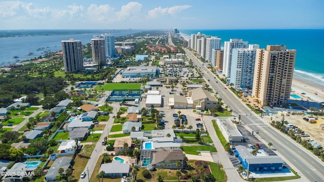 drone / aerial view featuring a water view and a beach view