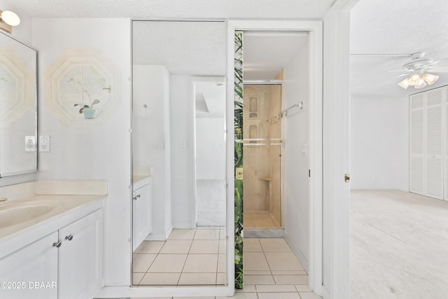 bathroom featuring ceiling fan, vanity, and tile patterned flooring