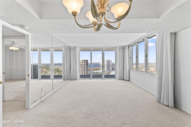 unfurnished sunroom with ceiling fan