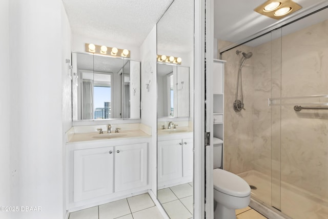 bathroom featuring toilet, a shower with door, tile patterned flooring, a textured ceiling, and vanity