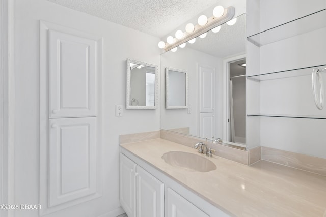 bathroom featuring a textured ceiling and vanity