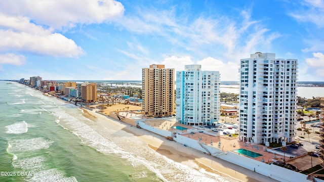 birds eye view of property with a beach view and a water view