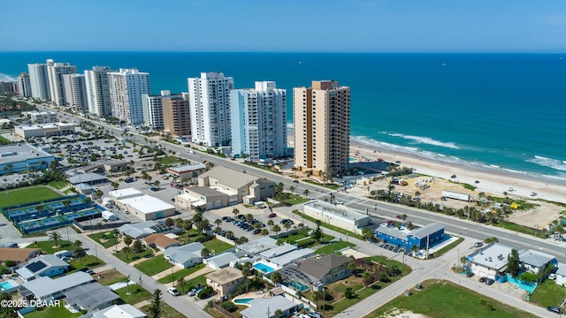 drone / aerial view featuring a water view and a beach view