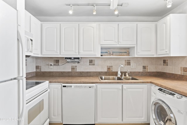 kitchen with washer / clothes dryer, sink, white appliances, and white cabinetry