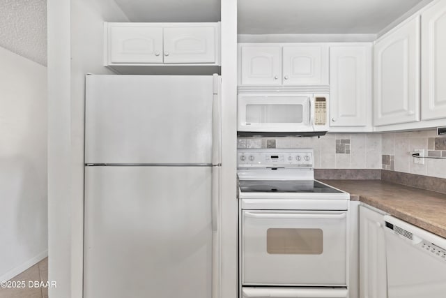 kitchen featuring white appliances, white cabinets, a textured ceiling, decorative backsplash, and light tile patterned flooring