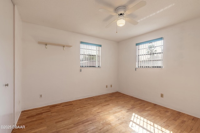 unfurnished room with ceiling fan, light hardwood / wood-style flooring, and a wealth of natural light