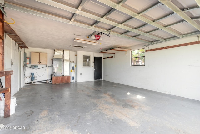 garage featuring a garage door opener, electric water heater, and heating unit