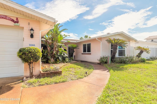 exterior space with a garage and a yard