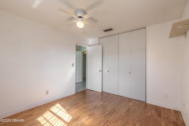 unfurnished bedroom with a closet, ceiling fan, and light hardwood / wood-style flooring