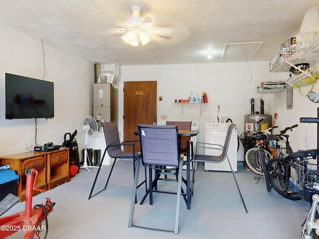 dining room featuring a ceiling fan, washer / clothes dryer, and concrete flooring