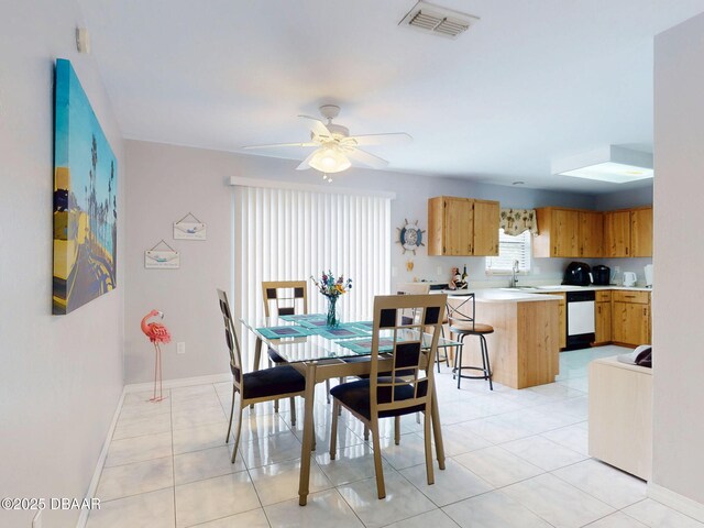 dining space with light tile patterned floors, baseboards, visible vents, and ceiling fan