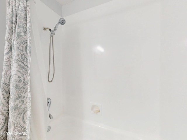 bathroom featuring shower / bathtub combination with curtain