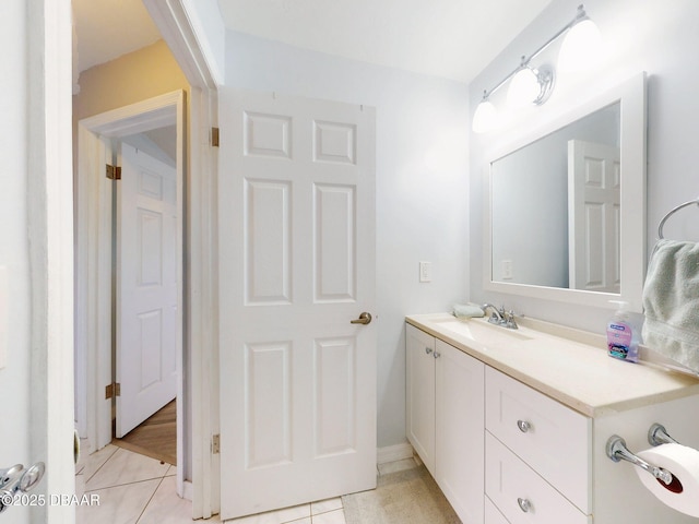 bathroom featuring tile patterned flooring and vanity