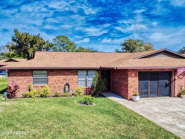 ranch-style home featuring a garage, concrete driveway, brick siding, and a front yard