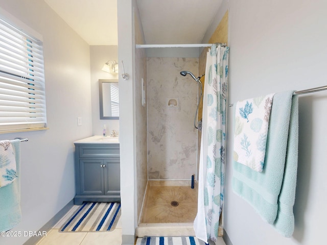 full bathroom with a stall shower, tile patterned flooring, and vanity