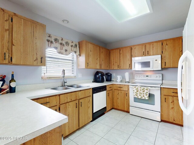 kitchen with white appliances, light countertops, and a sink