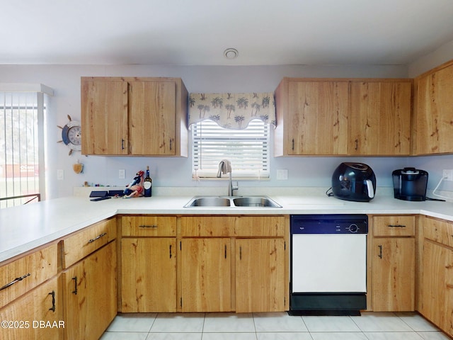 kitchen with light countertops, dishwasher, a sink, and light tile patterned floors