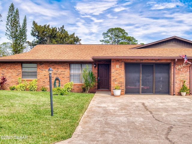 ranch-style house with driveway, a garage, roof with shingles, a front lawn, and brick siding