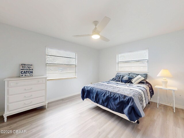 bedroom featuring light wood-style floors, ceiling fan, and baseboards