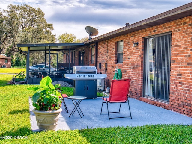 view of patio / terrace featuring grilling area and a sunroom