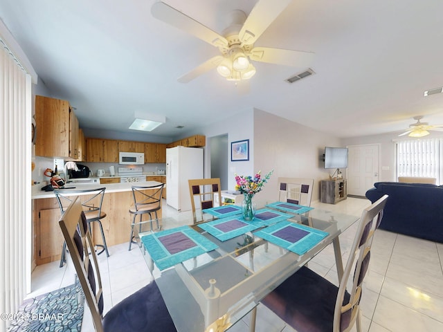 dining room featuring a ceiling fan, visible vents, and light tile patterned floors