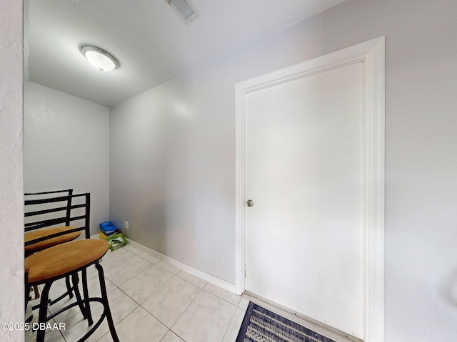 interior space with visible vents, baseboards, and light tile patterned flooring