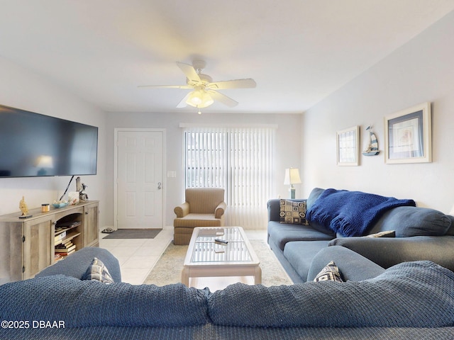 living area featuring a ceiling fan and tile patterned floors