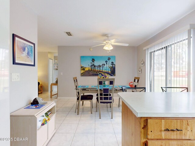 kitchen with light tile patterned floors, light countertops, ceiling fan, and visible vents