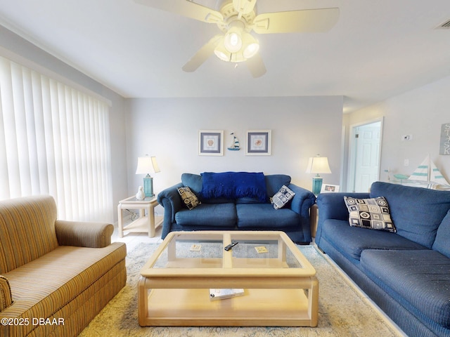 living area with visible vents and a ceiling fan