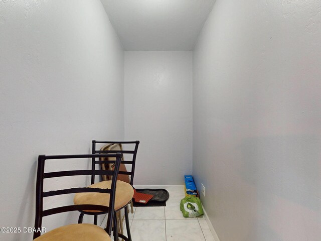 interior space featuring tile patterned flooring and baseboards