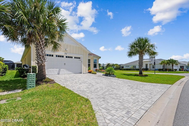 view of front of house featuring a garage and a front lawn