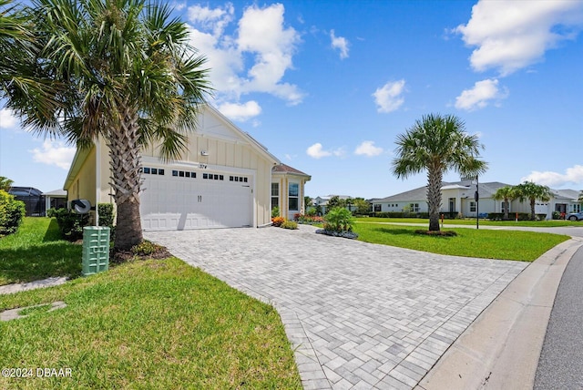 374 Lost Shaker Way, Daytona Beach, FL 32124 - single story home with board and batten siding, decorative driveway, an attached garage, a front lawn, and a residential view