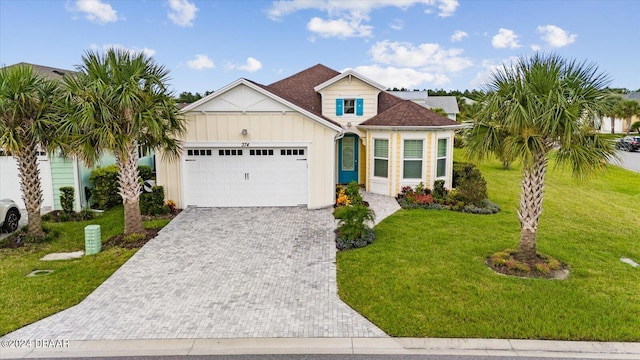 view of front of property with a front lawn and a garage