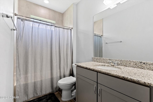 full bathroom with toilet, shower / tub combo, and vanity