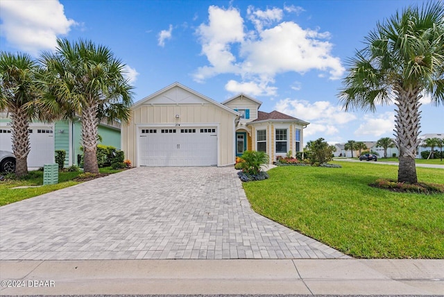 view of front of property with a garage and a front lawn