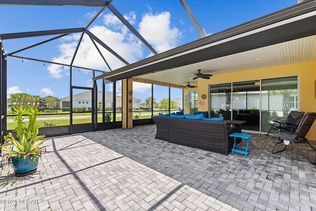 view of patio featuring an outdoor living space, a lanai, and ceiling fan