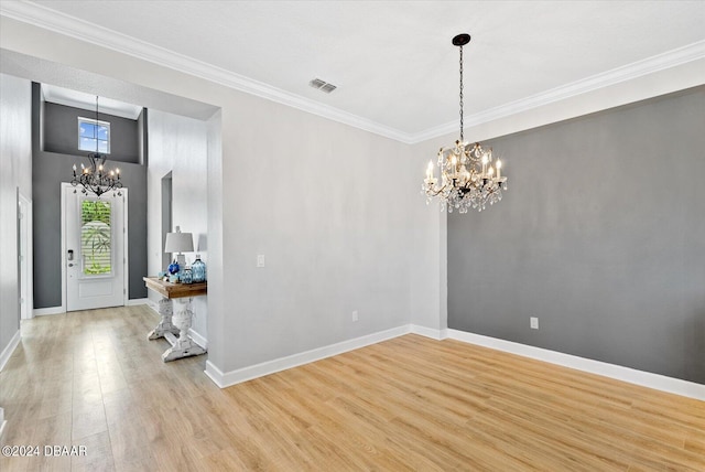 entryway featuring wood-type flooring, a notable chandelier, and ornamental molding