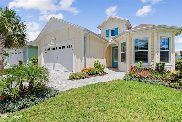 view of front of house with a garage and a front lawn