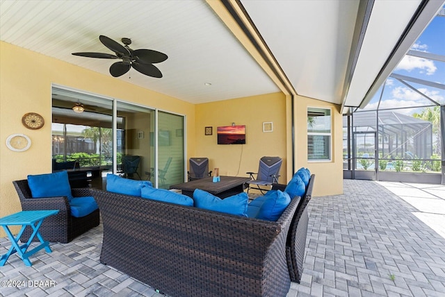 view of patio featuring ceiling fan, outdoor lounge area, and a lanai