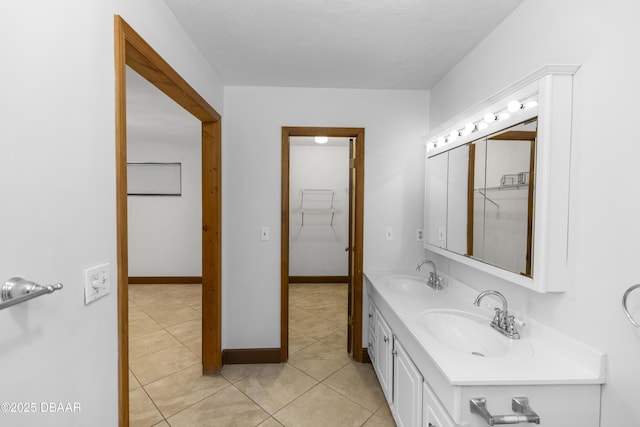 909 Brookside Dr, Ormond Beach, FL 32174 - bathroom featuring double vanity, tile patterned floors, and baseboards