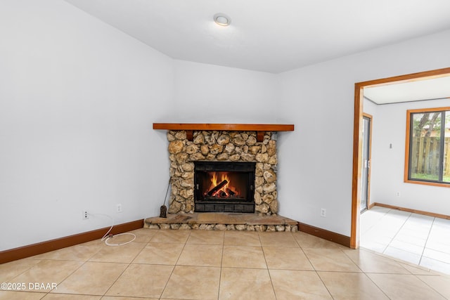 909 Brookside Dr, Ormond Beach, FL 32174 - unfurnished living room with light tile patterned floors, a stone fireplace, and baseboards