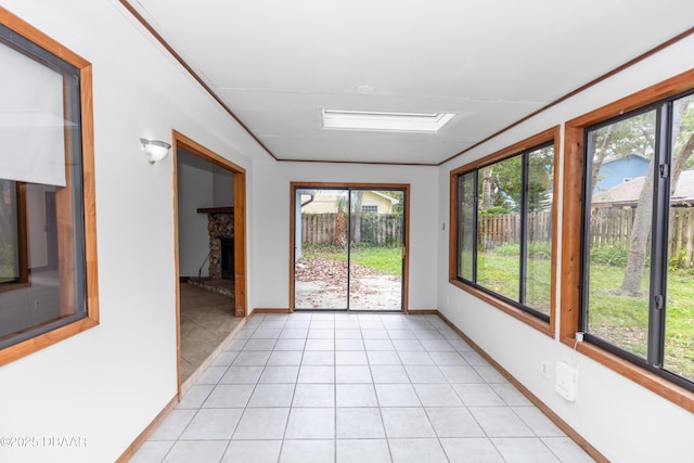 909 Brookside Dr, Ormond Beach, FL 32174 - unfurnished sunroom with plenty of natural light, tile patterned floors, and baseboards