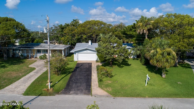 view of front of house with a garage and a front lawn