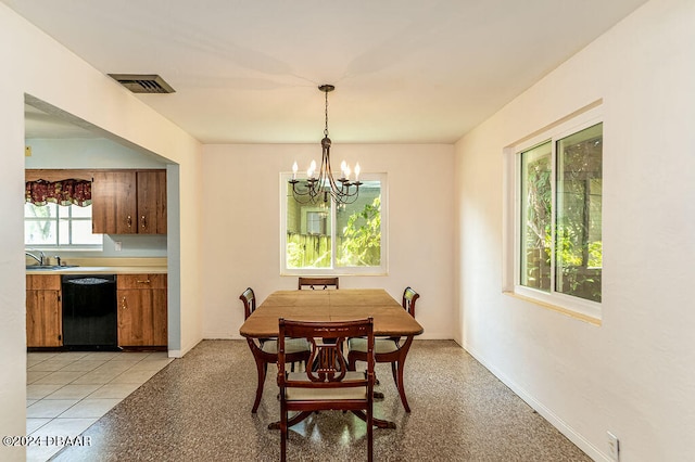 dining space featuring sink, a notable chandelier, and light tile patterned floors