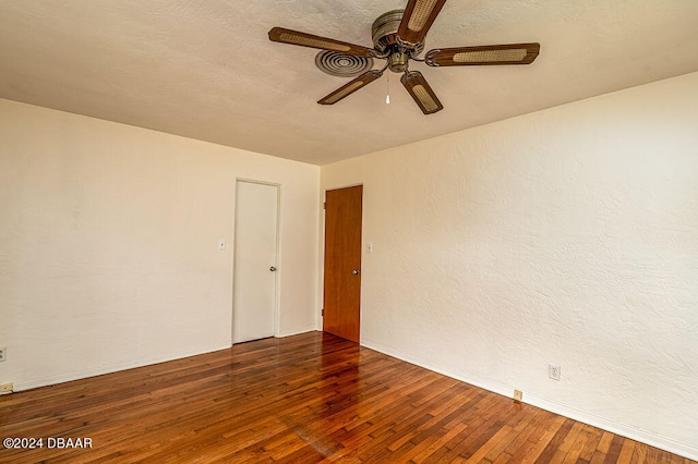 spare room with dark wood-type flooring and ceiling fan