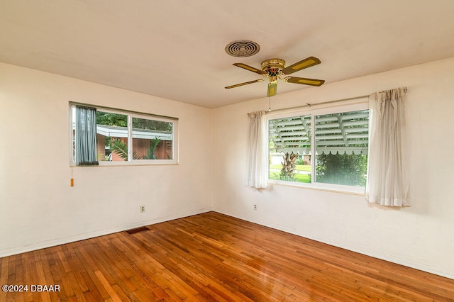 empty room featuring hardwood / wood-style flooring and ceiling fan