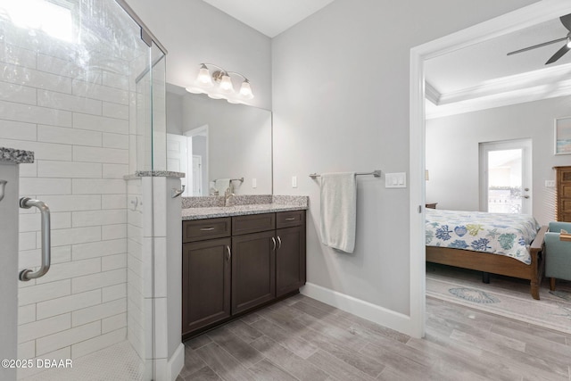 5 Chippeway Ct, Palm Coast, FL 32137 - full bath with a stall shower, baseboards, wood finished floors, a ceiling fan, and ensuite bathroom