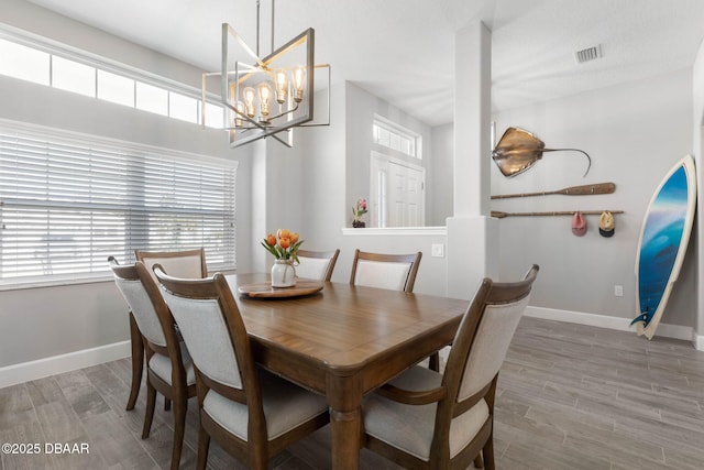 5 Chippeway Ct, Palm Coast, FL 32137 - dining space with plenty of natural light, a chandelier, wood finished floors, and baseboards